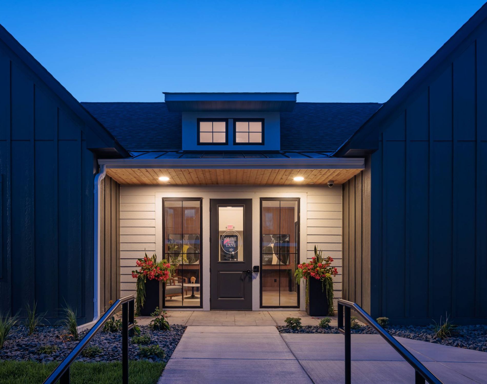 Olive Lane Townhomes clubhouse entrance at night