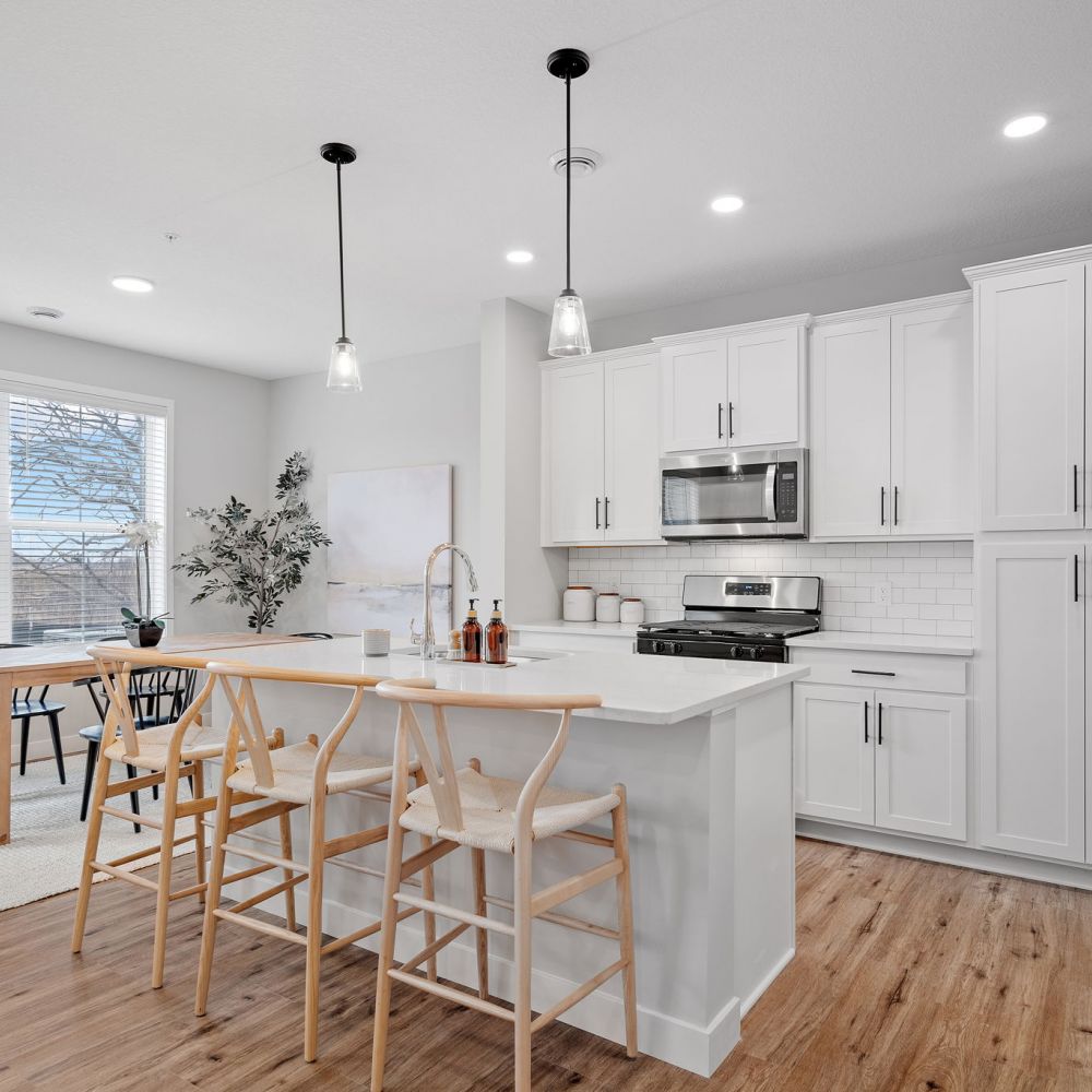 Olive lane kitchen with white finishes and black stools